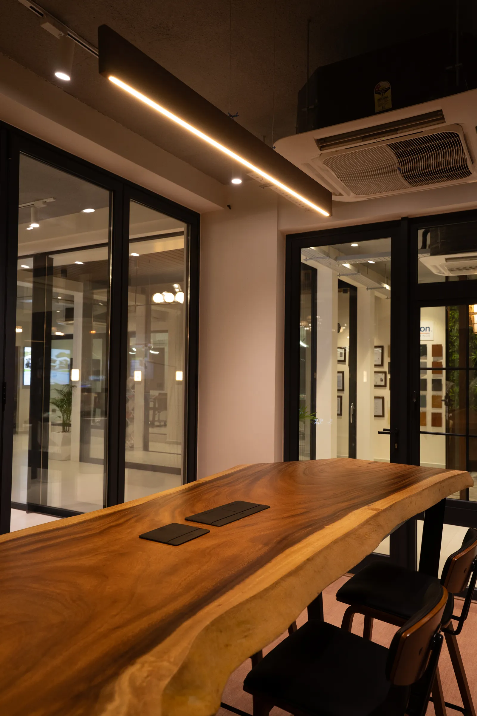 Live-edge wooden meeting table in the showroom — Aluk Experience Center